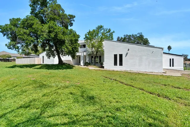 a front view of house with yard and trees