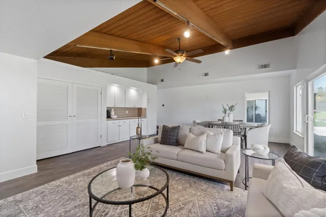 a living room with furniture and a wooden floor