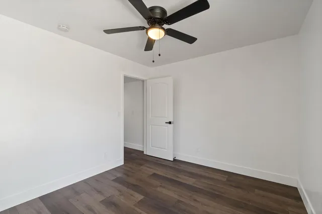 a view of an empty room and wooden floor