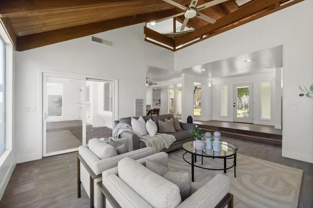 a living room with furniture and a chandelier