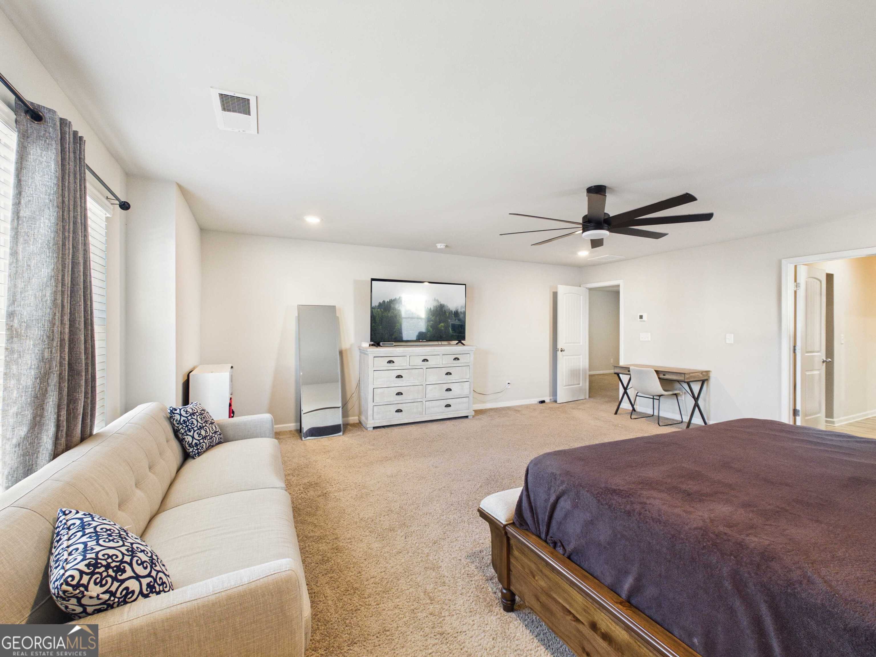 197 Stocks Circle West Point, GA 31833 - Photo 11 of 63 a bedroom with a large bed and a window