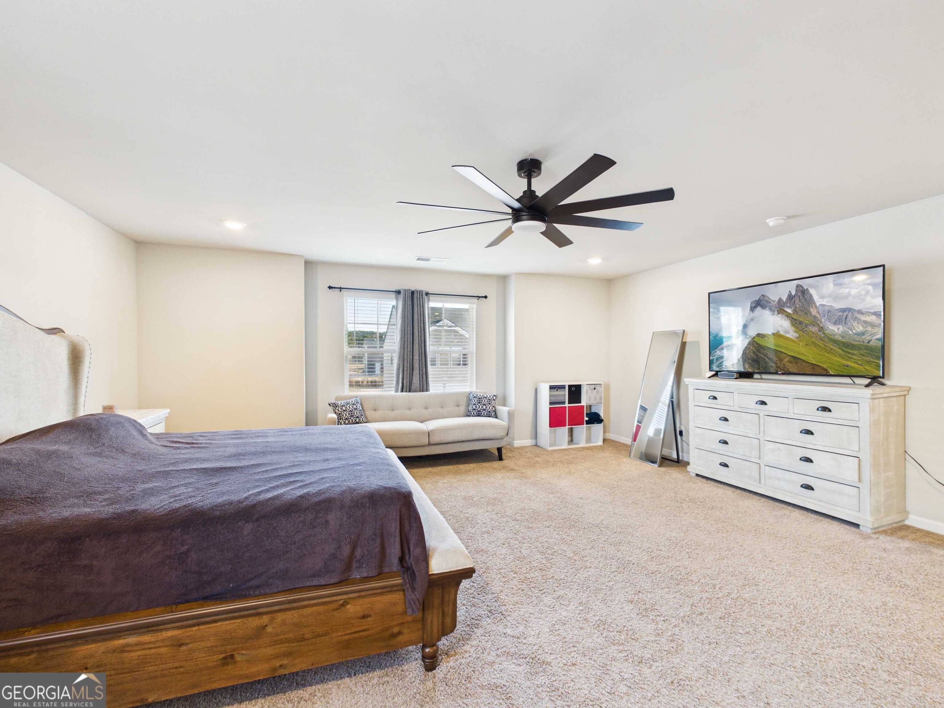 197 Stocks Circle West Point, GA 31833 - Photo 12 of 63 a bedroom with a bed a flat screen tv and dresser