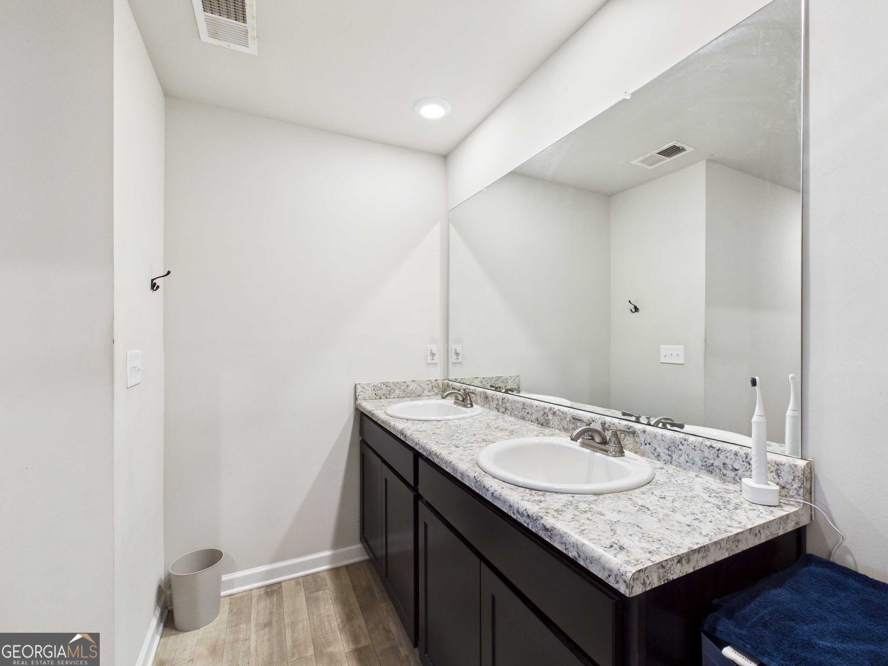 197 Stocks Circle West Point, GA 31833 - Photo 13 of 63 a bathroom with a granite countertop sink and a mirror