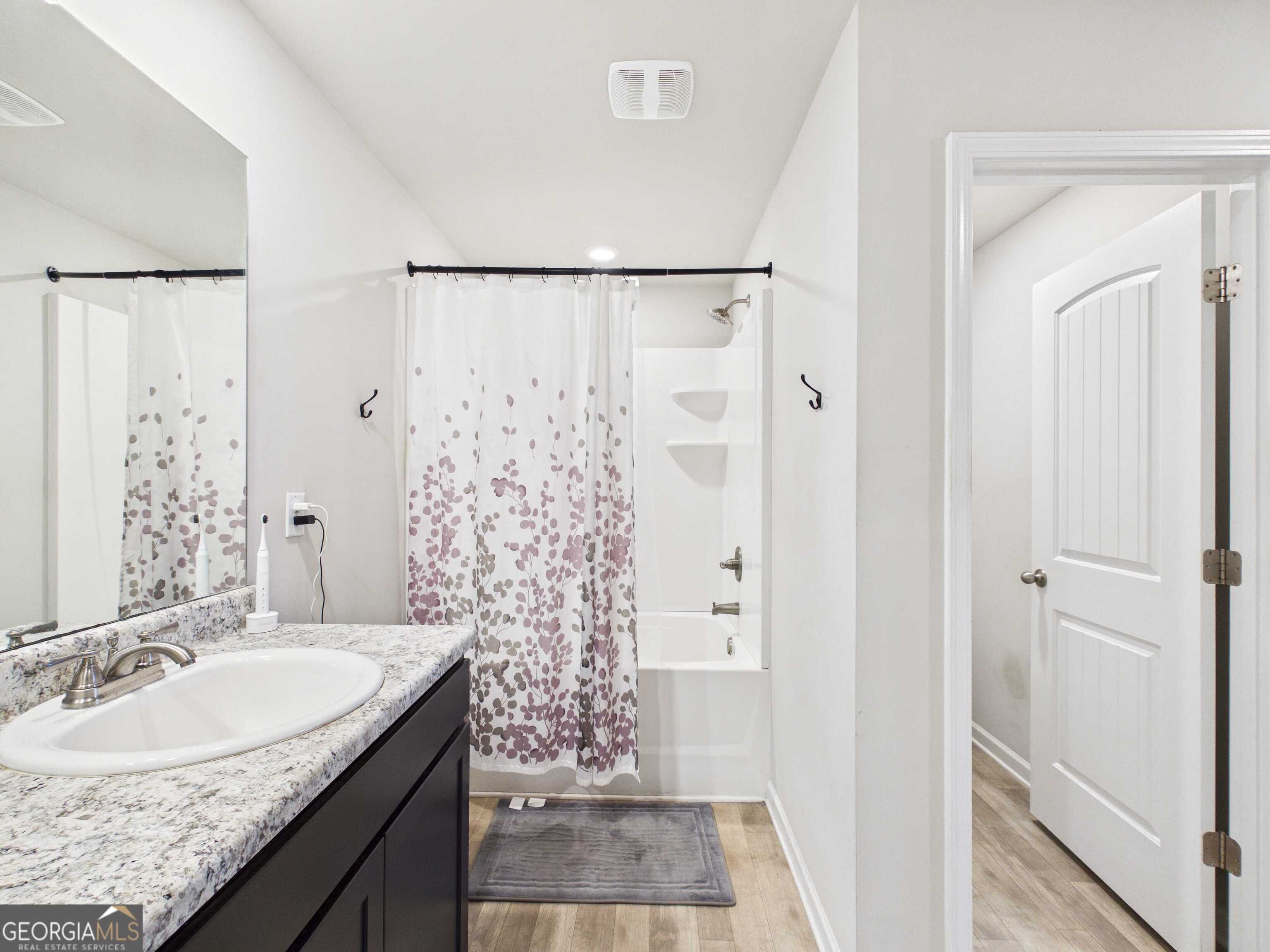 197 Stocks Circle West Point, GA 31833 - Photo 14 of 63 a bathroom with a granite countertop sink a mirror a shower and a sink