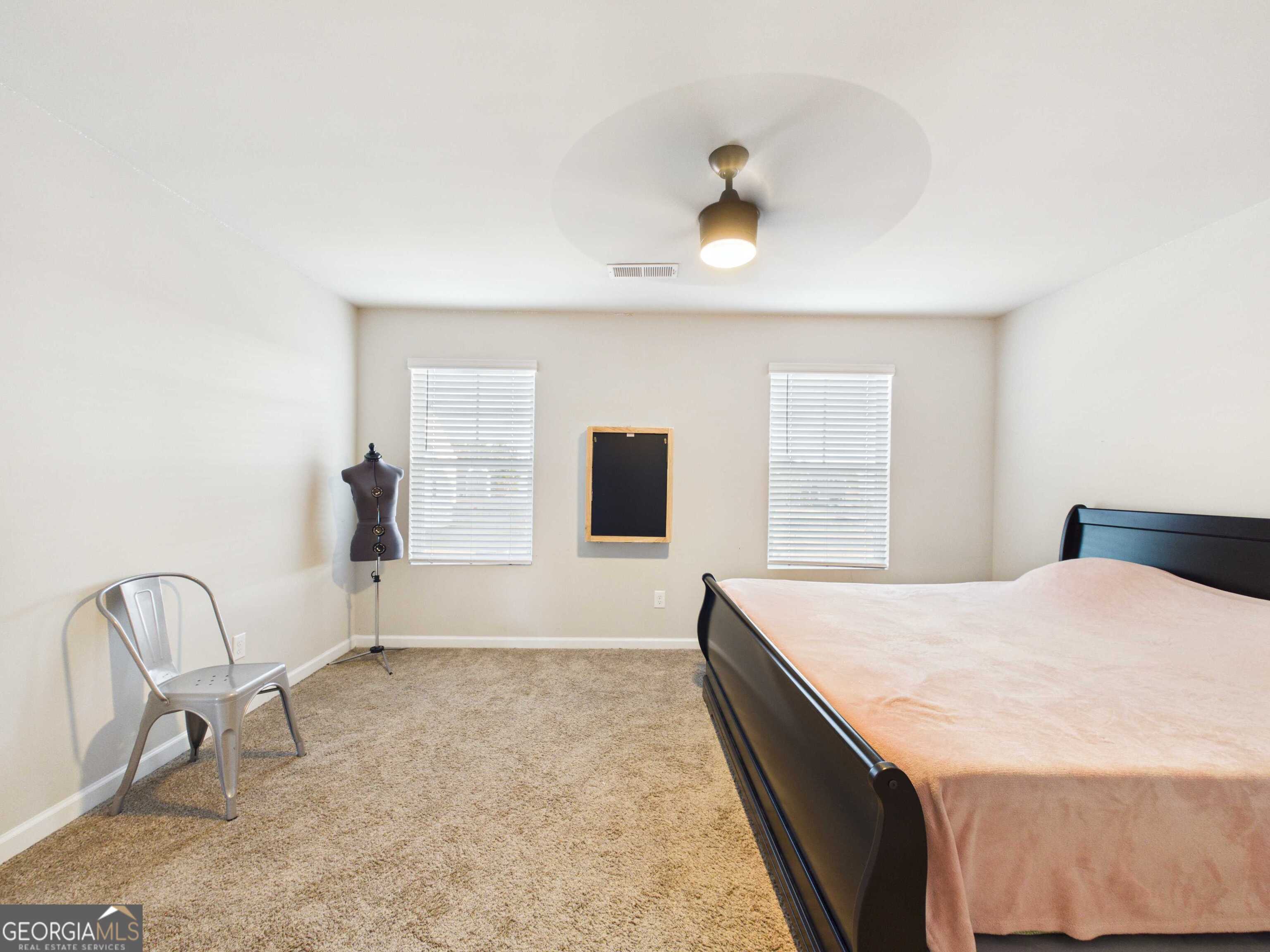 197 Stocks Circle West Point, GA 31833 - Photo 31 of 63 a spacious bedroom with a bed and a table in it