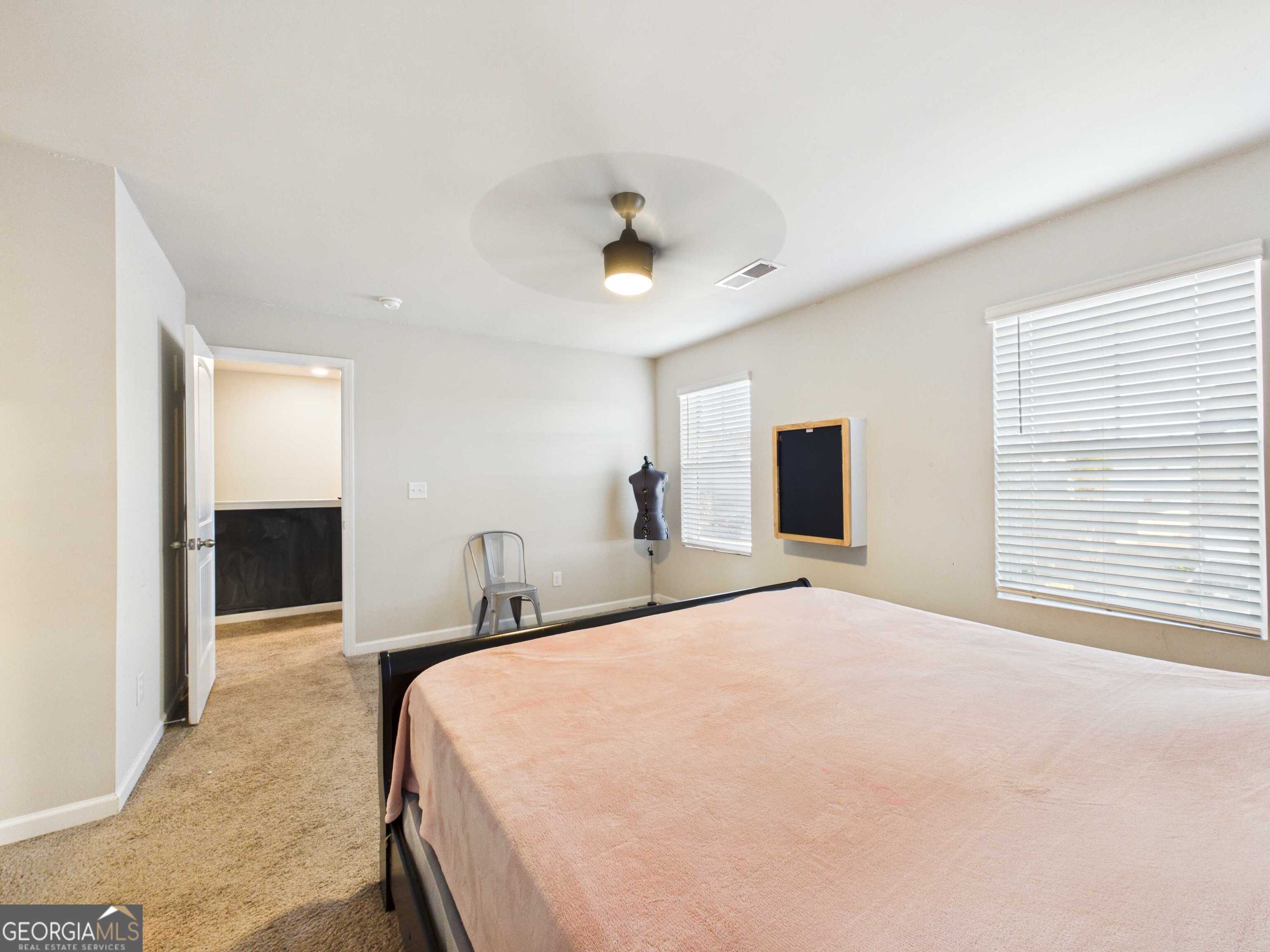 197 Stocks Circle West Point, GA 31833 - Photo 33 of 63 a bedroom with a large bed and a chandelier