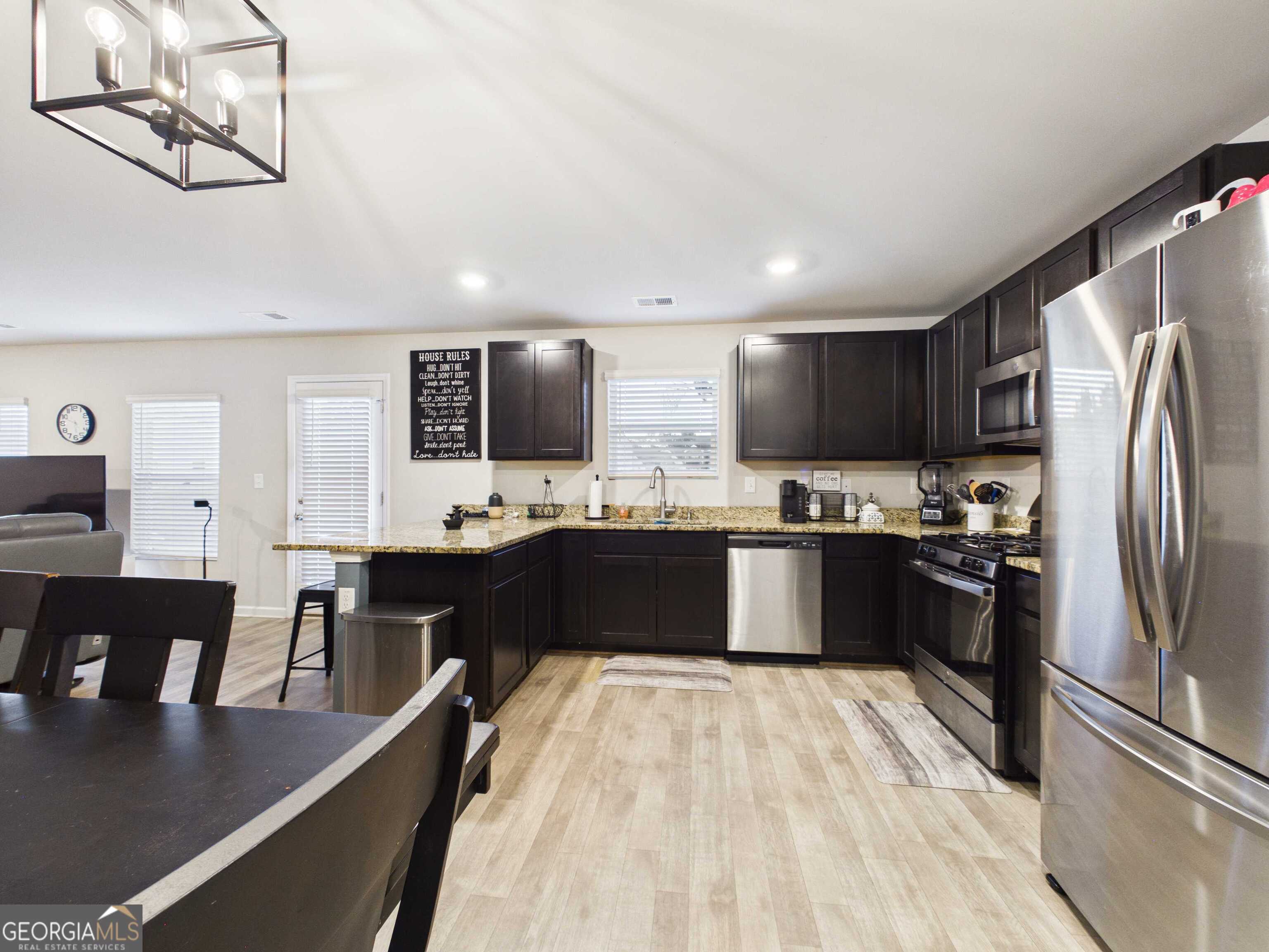 197 Stocks Circle West Point, GA 31833 - Photo 47 of 63 a large kitchen with stainless steel appliances a refrigerator a sink dishwasher a stove top oven a counter space and cabinets