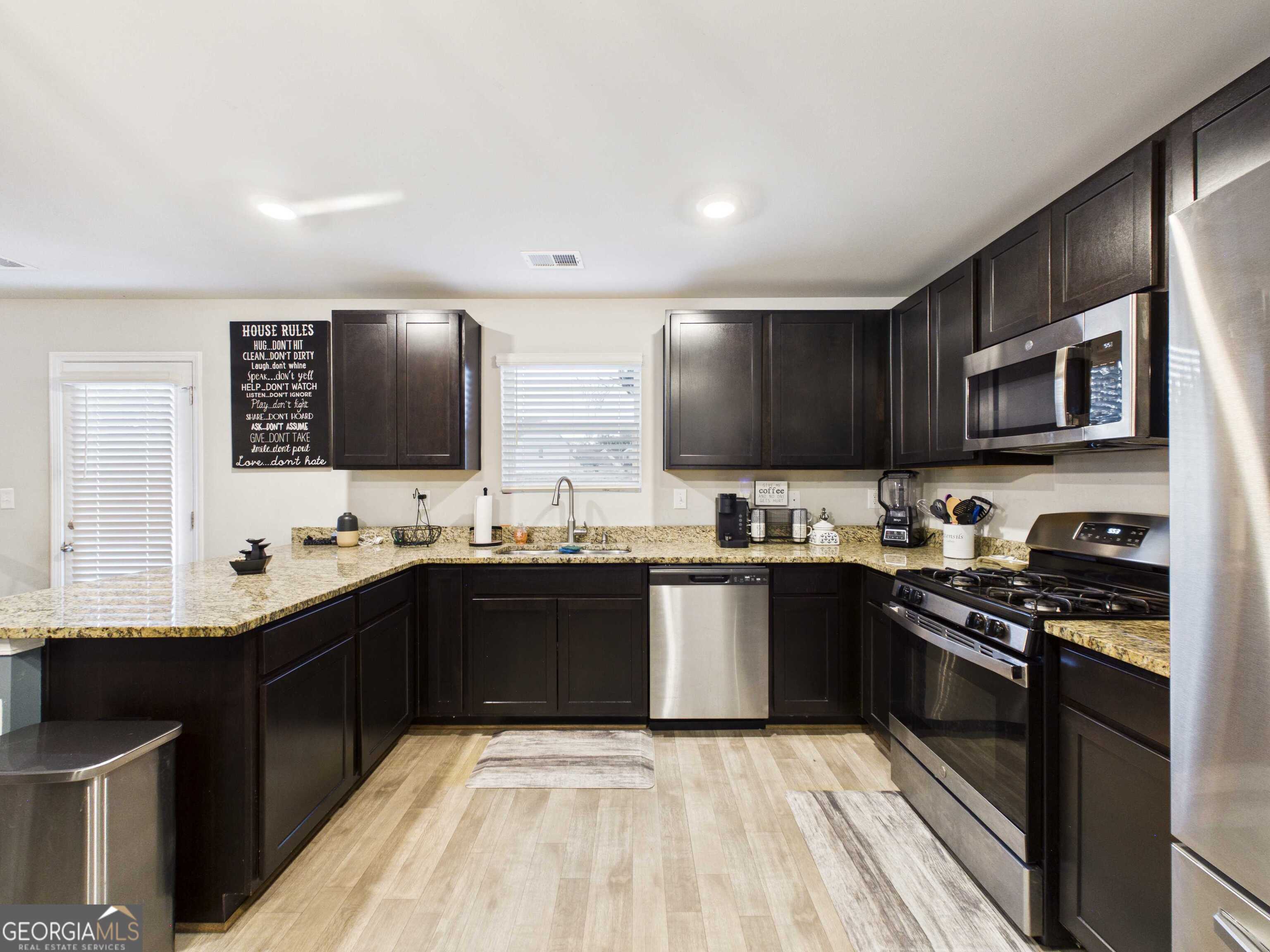 197 Stocks Circle West Point, GA 31833 - Photo 48 of 63 a kitchen with stainless steel appliances granite countertop a sink and stove top oven