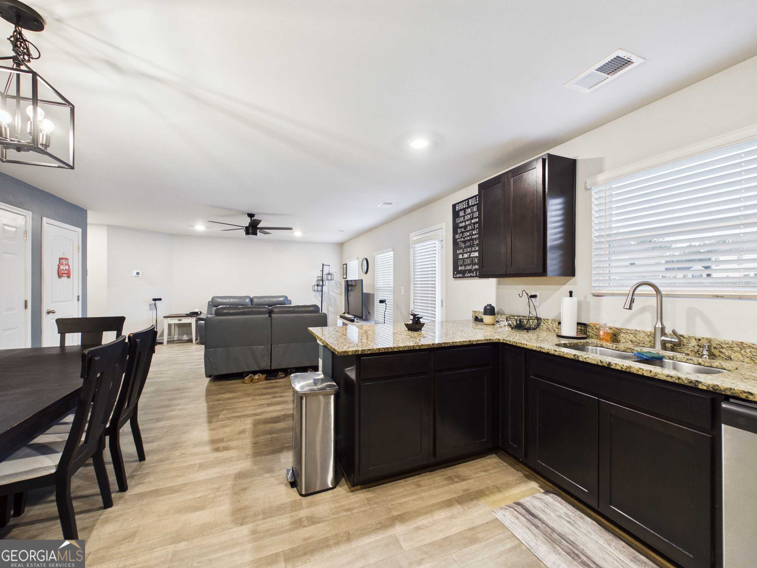 197 Stocks Circle West Point, GA 31833 - Photo 50 of 63 a kitchen with sink a microwave and cabinets