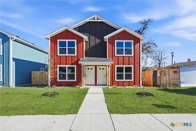 a front view of a house with a yard