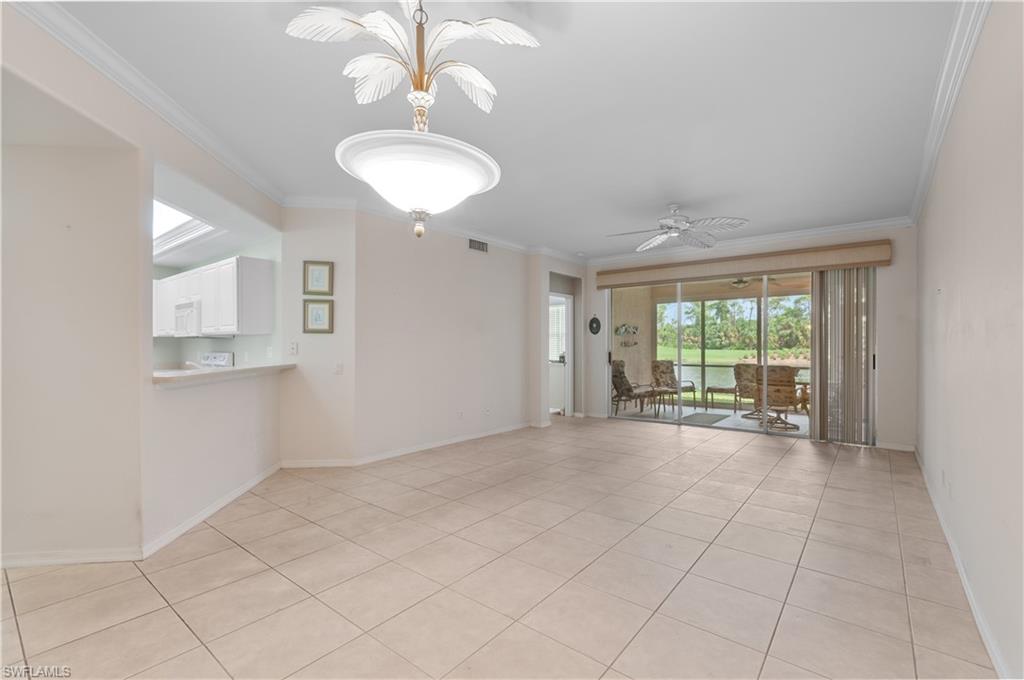 9341 Spring Run Boulevard, Unit 3106 Estero, FL 34135 - Photo 13 of 44 Unfurnished room with light tile floors, crown molding, ceiling fan, and a chandelier