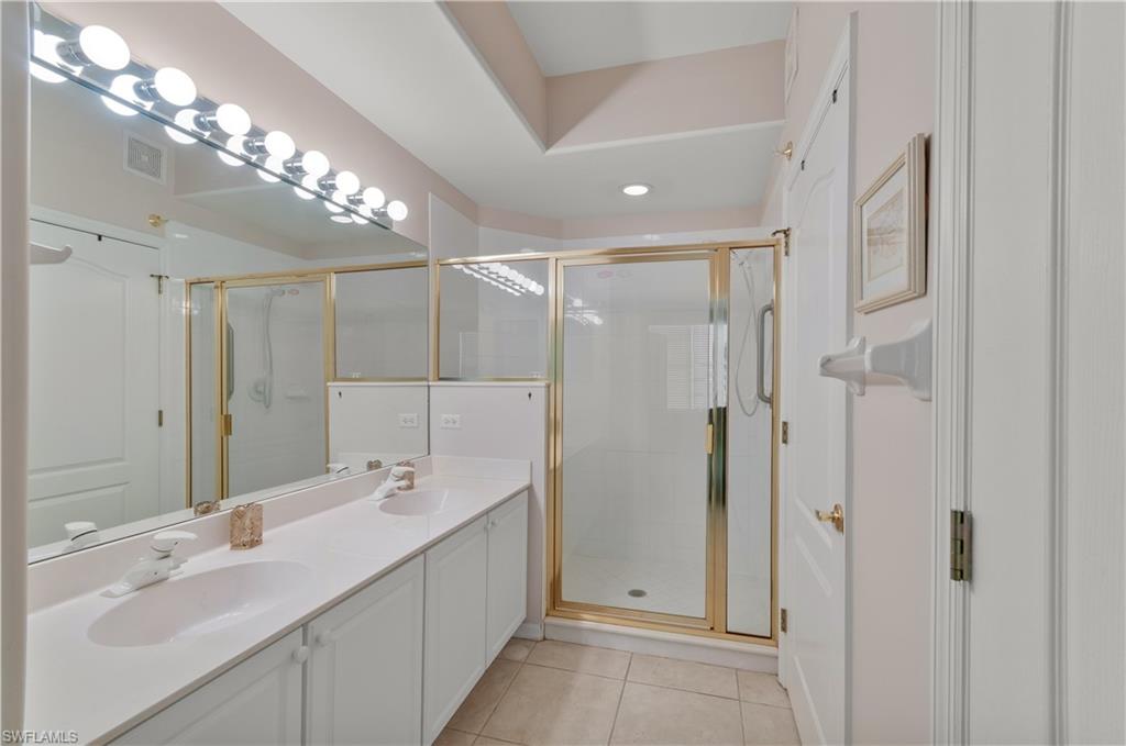 9341 Spring Run Boulevard, Unit 3106 Estero, FL 34135 - Photo 15 of 44 Bathroom with light tile floors, a stall shower, and double vanity
