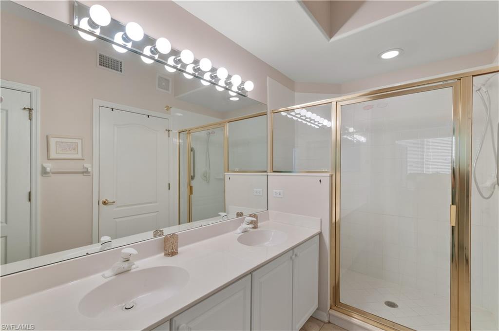 9341 Spring Run Boulevard, Unit 3106 Estero, FL 34135 - Photo 16 of 44 Bathroom featuring a shower stall and double vanity