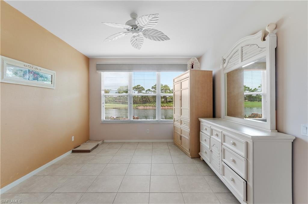 9341 Spring Run Boulevard, Unit 3106 Estero, FL 34135 - Photo 19 of 44 Unfurnished bedroom featuring multiple windows, light tile flooring, and a ceiling fan