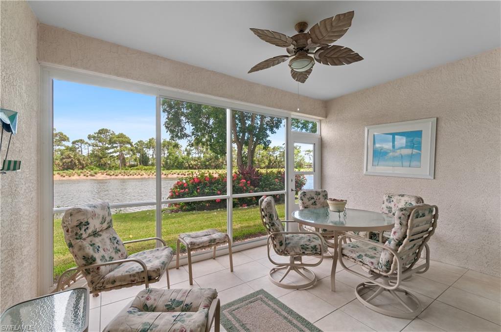 9341 Spring Run Boulevard, Unit 3106 Estero, FL 34135 - Photo 25 of 44 Lanai featuring a textured wall, tile floors, and a water view
