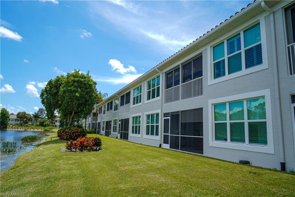 9341 Spring Run Boulevard, Unit 3106 Estero, FL 34135 - Photo 28 of 44 View of green lawn featuring a lanai