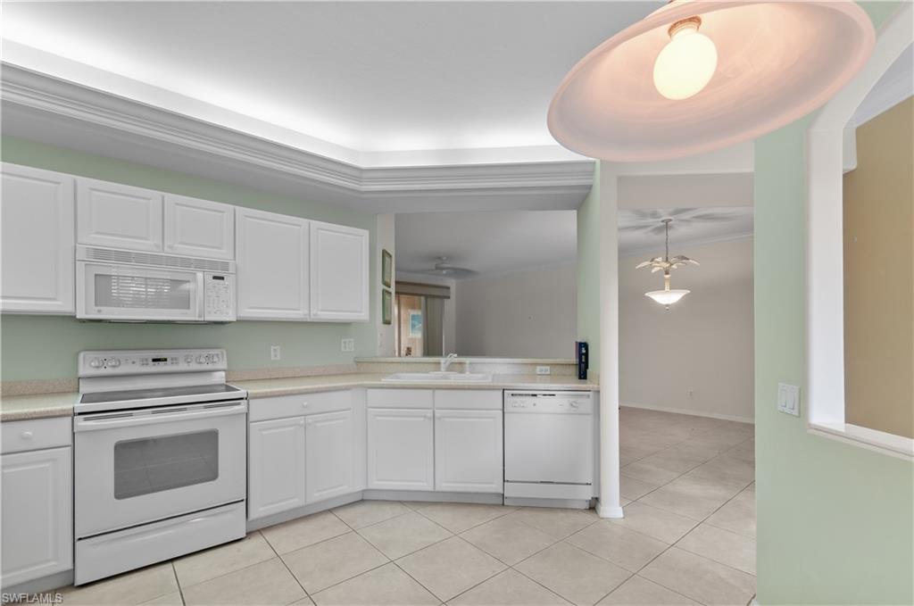 9341 Spring Run Boulevard, Unit 3106 Estero, FL 34135 - Photo 7 of 44 Kitchen with white appliances, white cabinetry, light countertops, light tile flooring, and ceiling fan