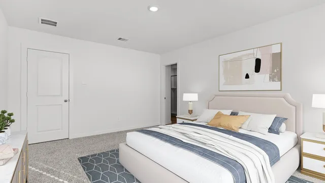 a bedroom with a bed and a painting on the wall