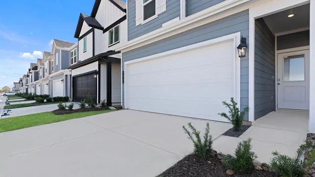 a view of a house with a yard and potted plants