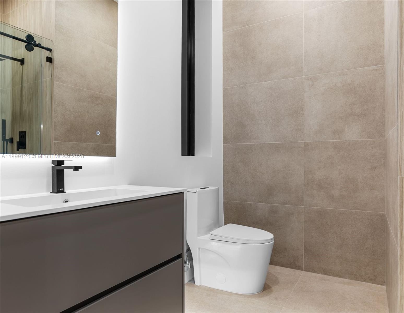 2823 Southwest 23rd Terrace, Unit 2823 Miami, FL 33145 - Photo 25 of 32 a bathroom with a toilet a sink and mirror