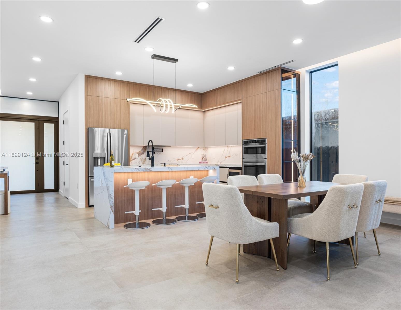2823 Southwest 23rd Terrace, Unit 2823 Miami, FL 33145 - Photo 6 of 32 a dining hall with stainless steel appliances a dining table and chairs