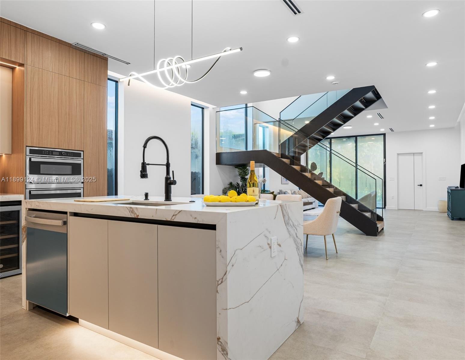 2823 Southwest 23rd Terrace, Unit 2823 Miami, FL 33145 - Photo 7 of 32 a kitchen with stainless steel appliances granite countertop a sink and a refrigerator