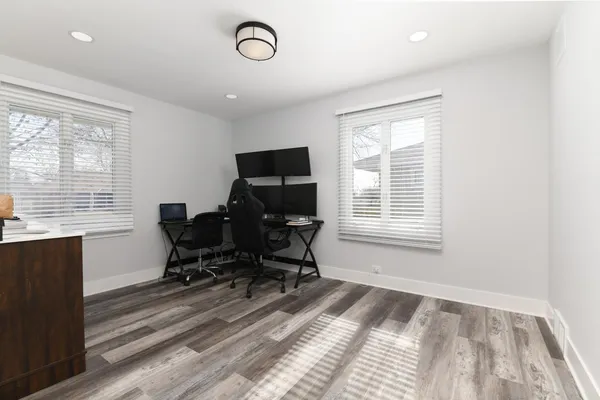 a view of workspace with wooden floor windows and piano