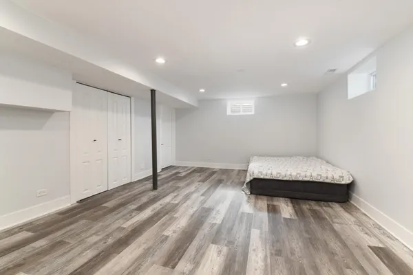 a view of a bedroom with wooden floor