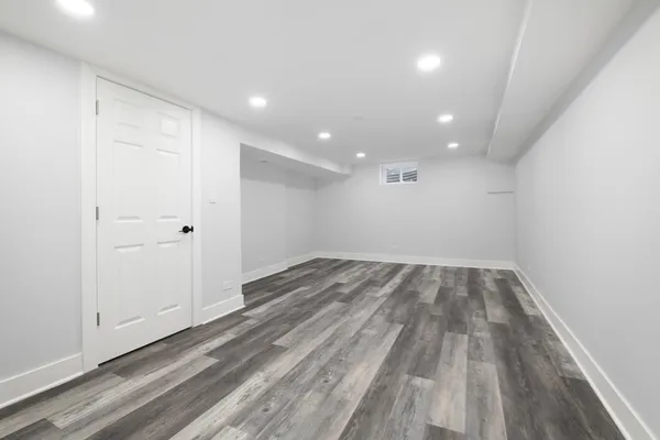 a view of wooden floor and windows in a room