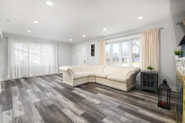 a living room with furniture and a large window