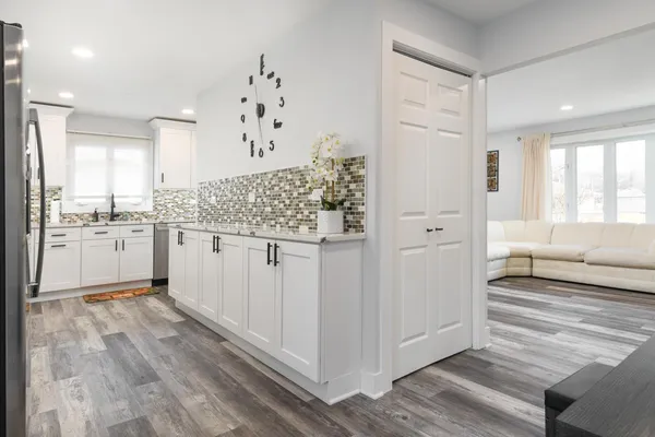 a bathroom with a granite countertop sink a mirror and a bathtub