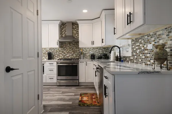 a kitchen with granite countertop a sink and a stove top oven