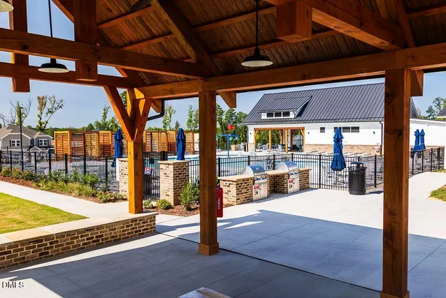 a view of a patio with a table chairs and a backyard