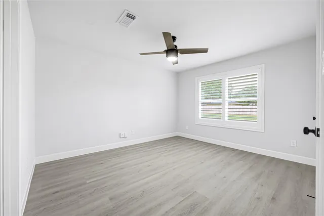 a view of a hallway with wooden shelves