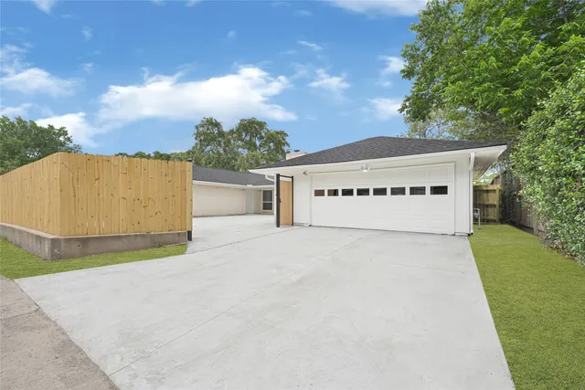a view of a house with a yard and garage
