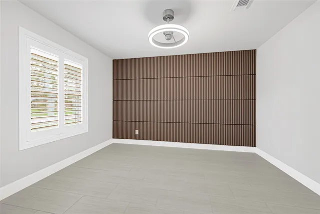 a kitchen with kitchen island granite countertop a sink cabinets and stainless steel appliances