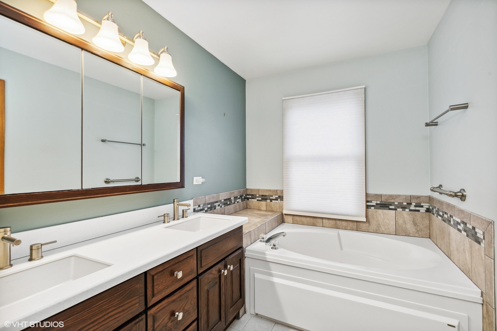 1101 Spring Creek Court Elgin, IL 60120 - Photo 13 of 18 a bathroom with a tub a sink and mirror