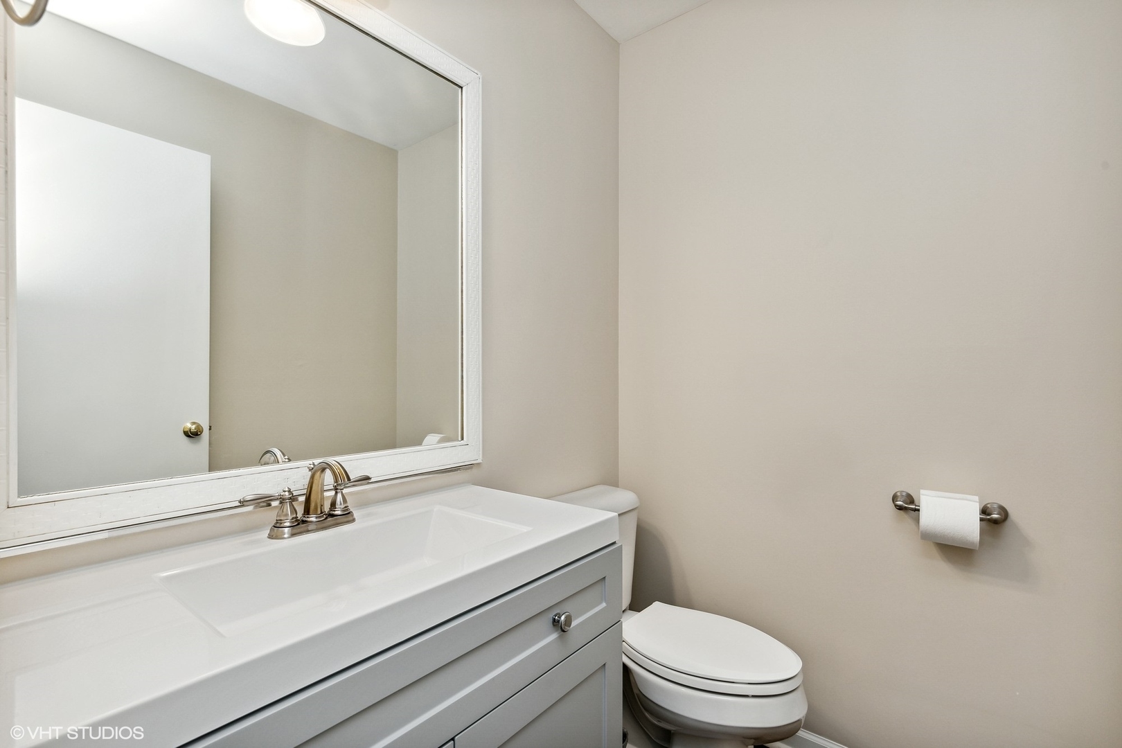 1101 Spring Creek Court Elgin, IL 60120 - Photo 6 of 18 a bathroom with a sink a toilet and a mirror