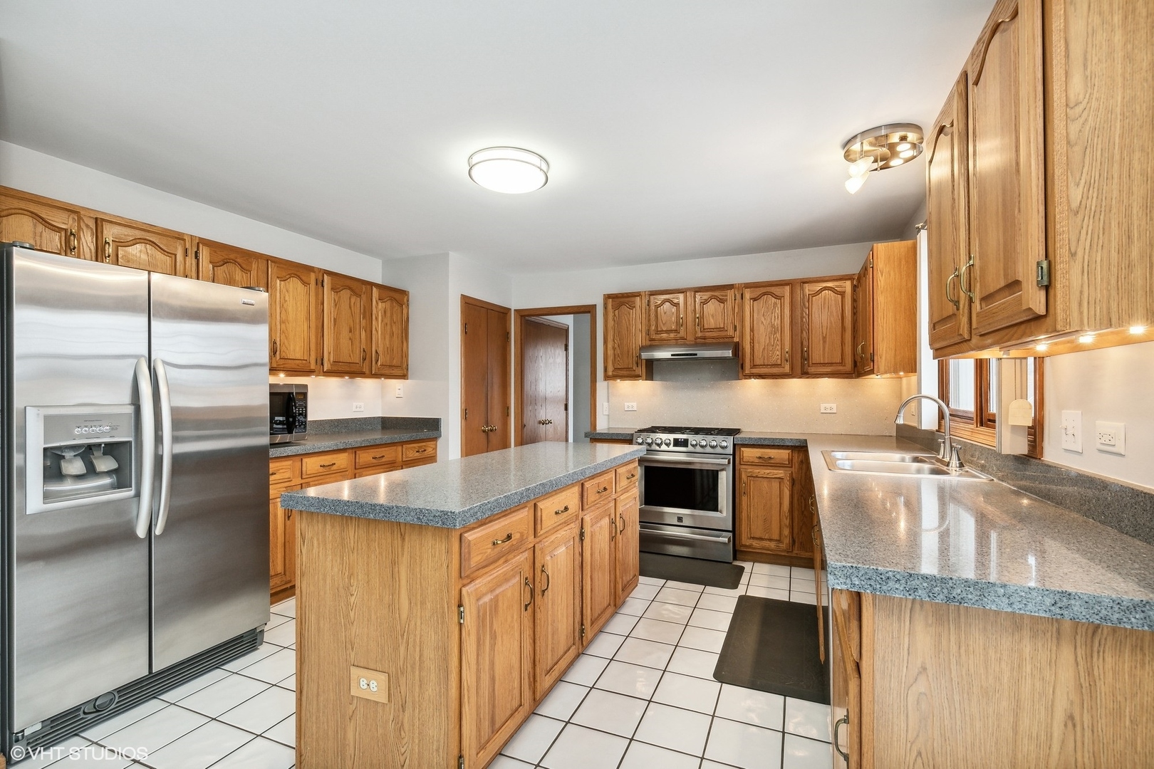 1101 Spring Creek Court Elgin, IL 60120 - Photo 8 of 18 a kitchen with stainless steel appliances granite countertop a sink stove and refrigerator