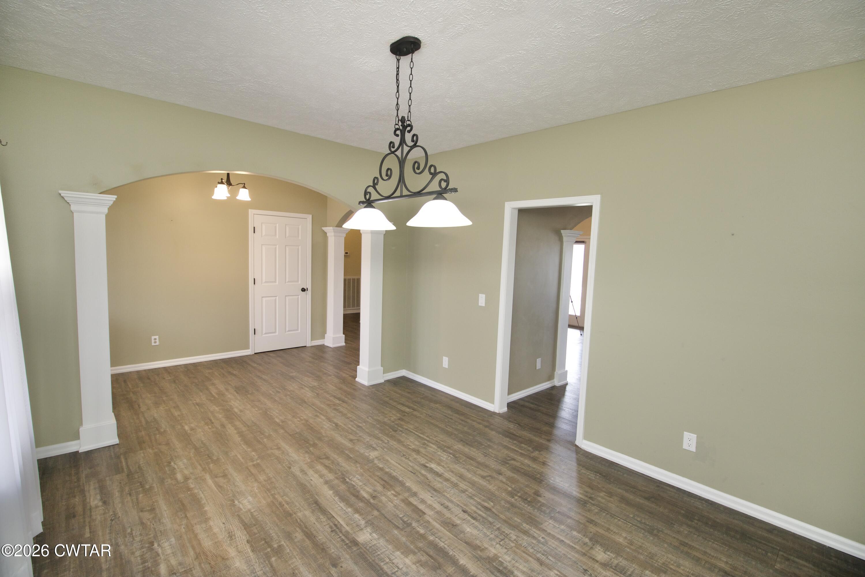 2845 Gilchrist Stantonville Road Stantonville, TN 38379 - Photo 13 of 97 a view of a room with wooden floor and chandelier