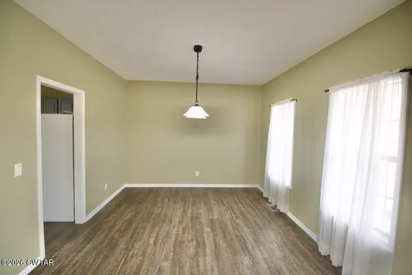 a kitchen with a center island a sink cabinets and wooden floor