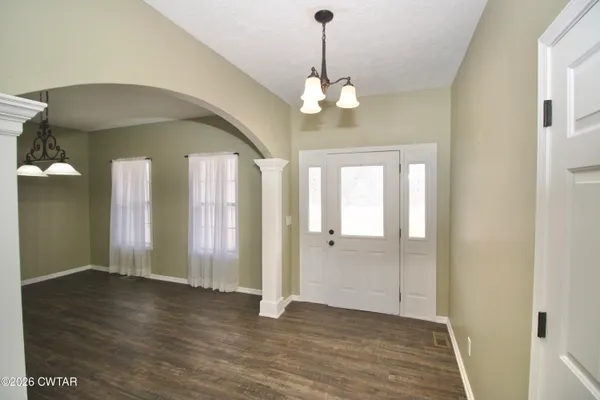 a kitchen with stainless steel appliances granite countertop a sink refrigerator and cabinets