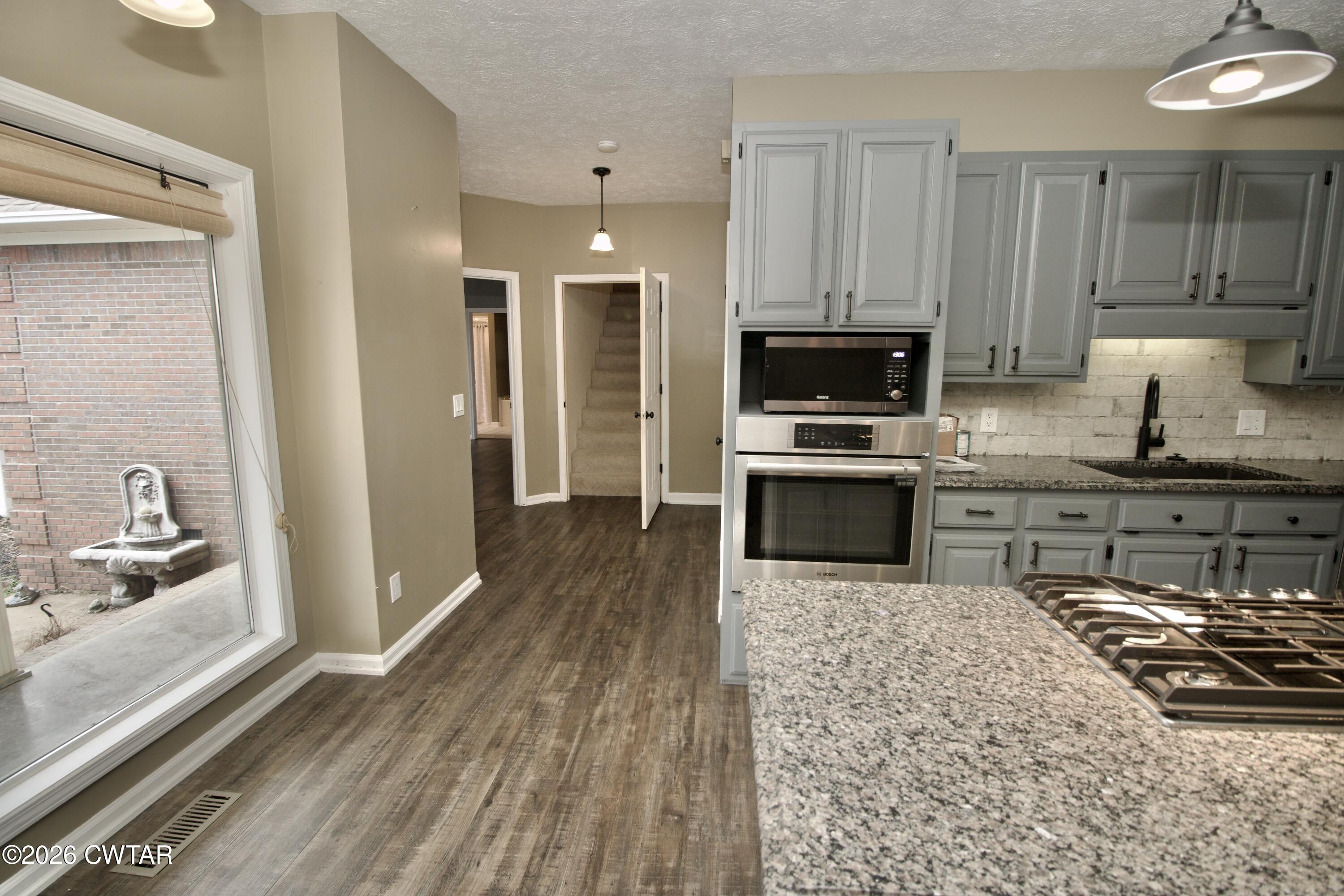 2845 Gilchrist Stantonville Road Stantonville, TN 38379 - Photo 22 of 97 a kitchen with granite countertop a stove and a sink