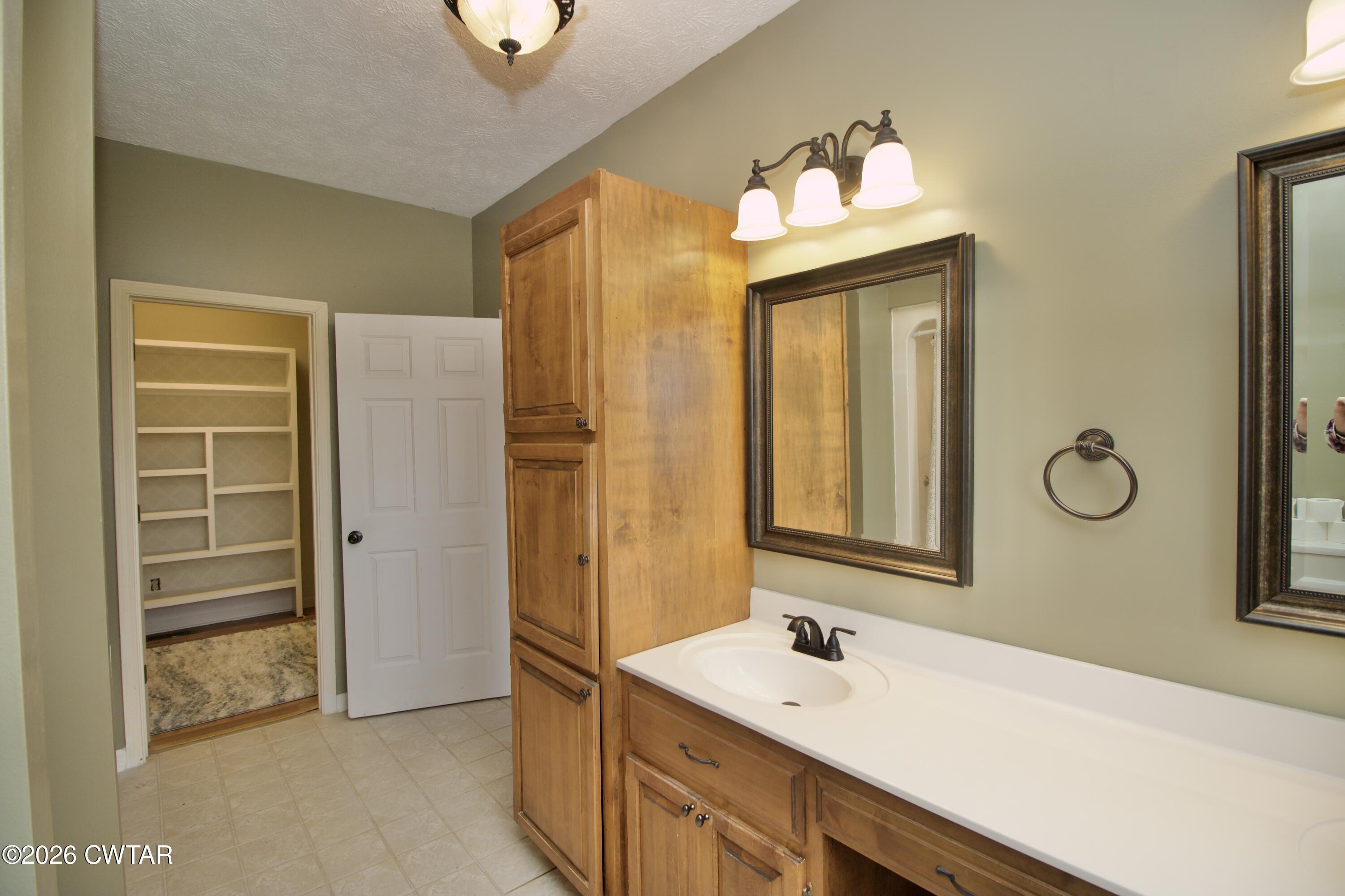 2845 Gilchrist Stantonville Road Stantonville, TN 38379 - Photo 31 of 97 a bathroom with a sink a mirror and a shower