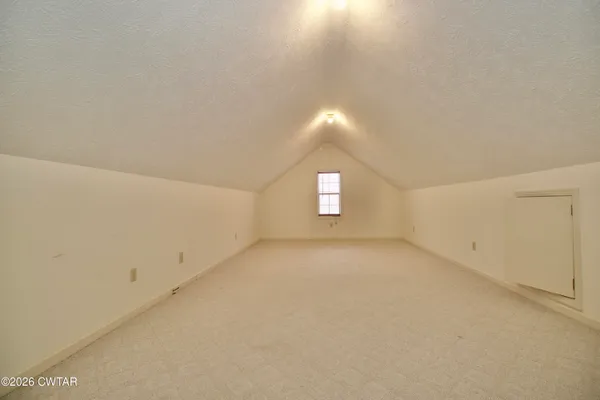 a view of a garage with wooden table and chairs