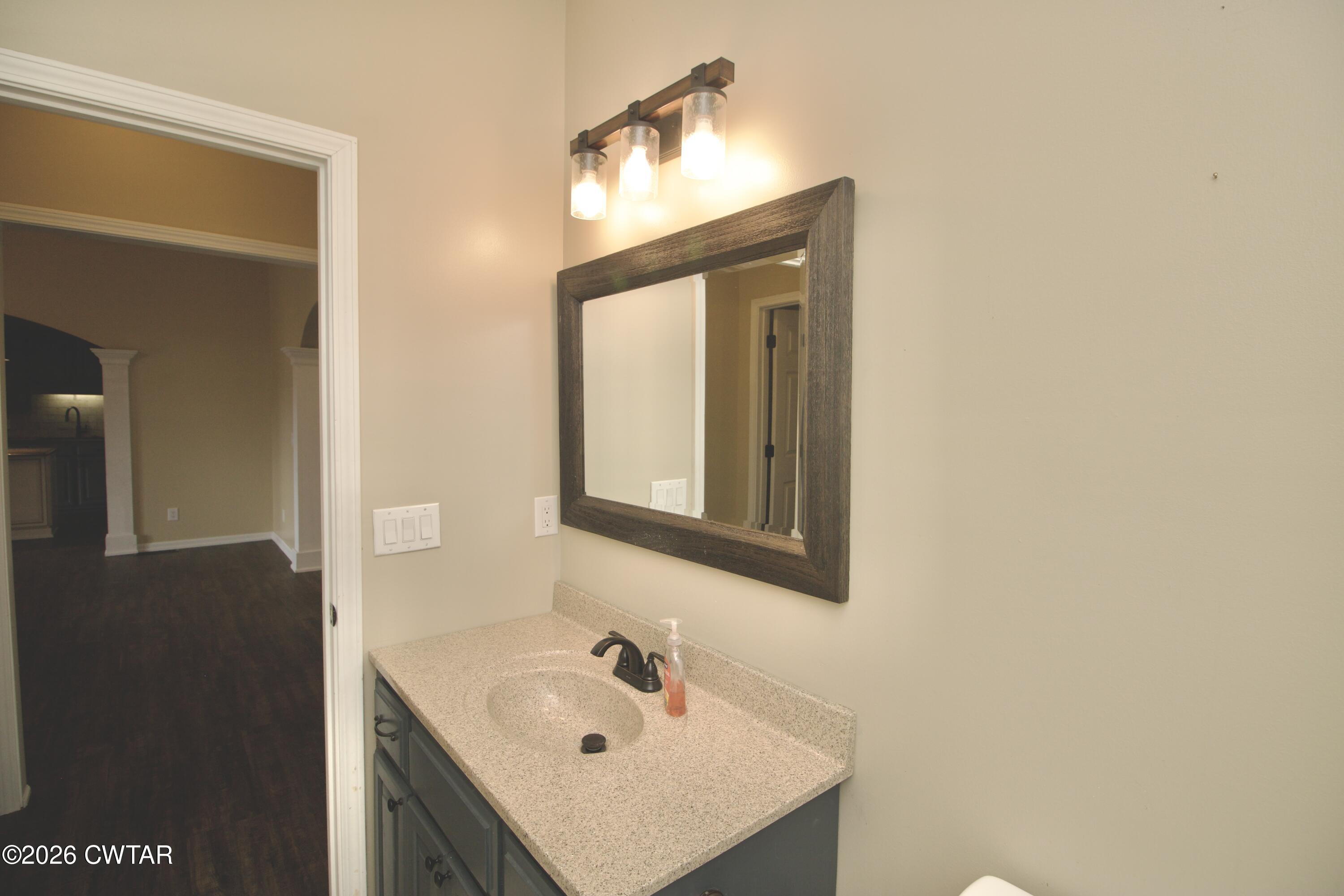 2845 Gilchrist Stantonville Road Stantonville, TN 38379 - Photo 42 of 97 a bathroom with a sink and a mirror