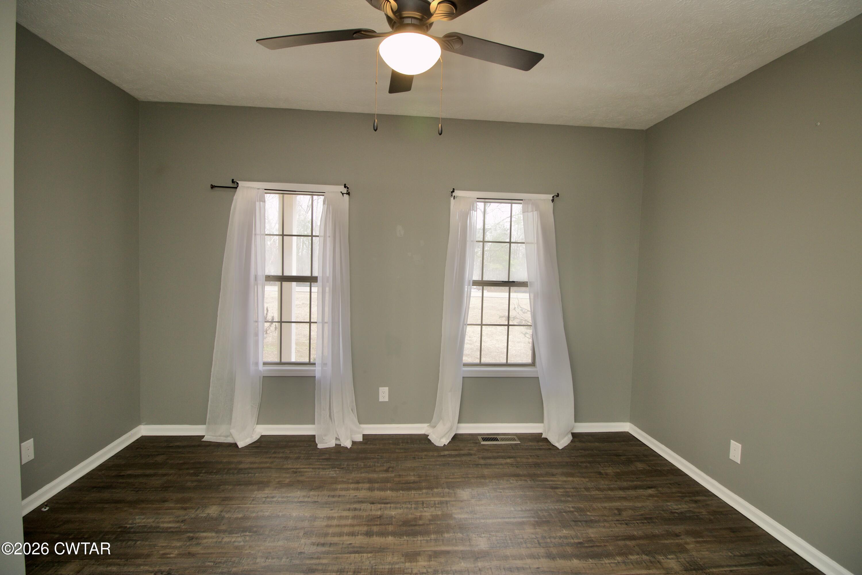 2845 Gilchrist Stantonville Road Stantonville, TN 38379 - Photo 43 of 97 an empty room with wooden floor and windows