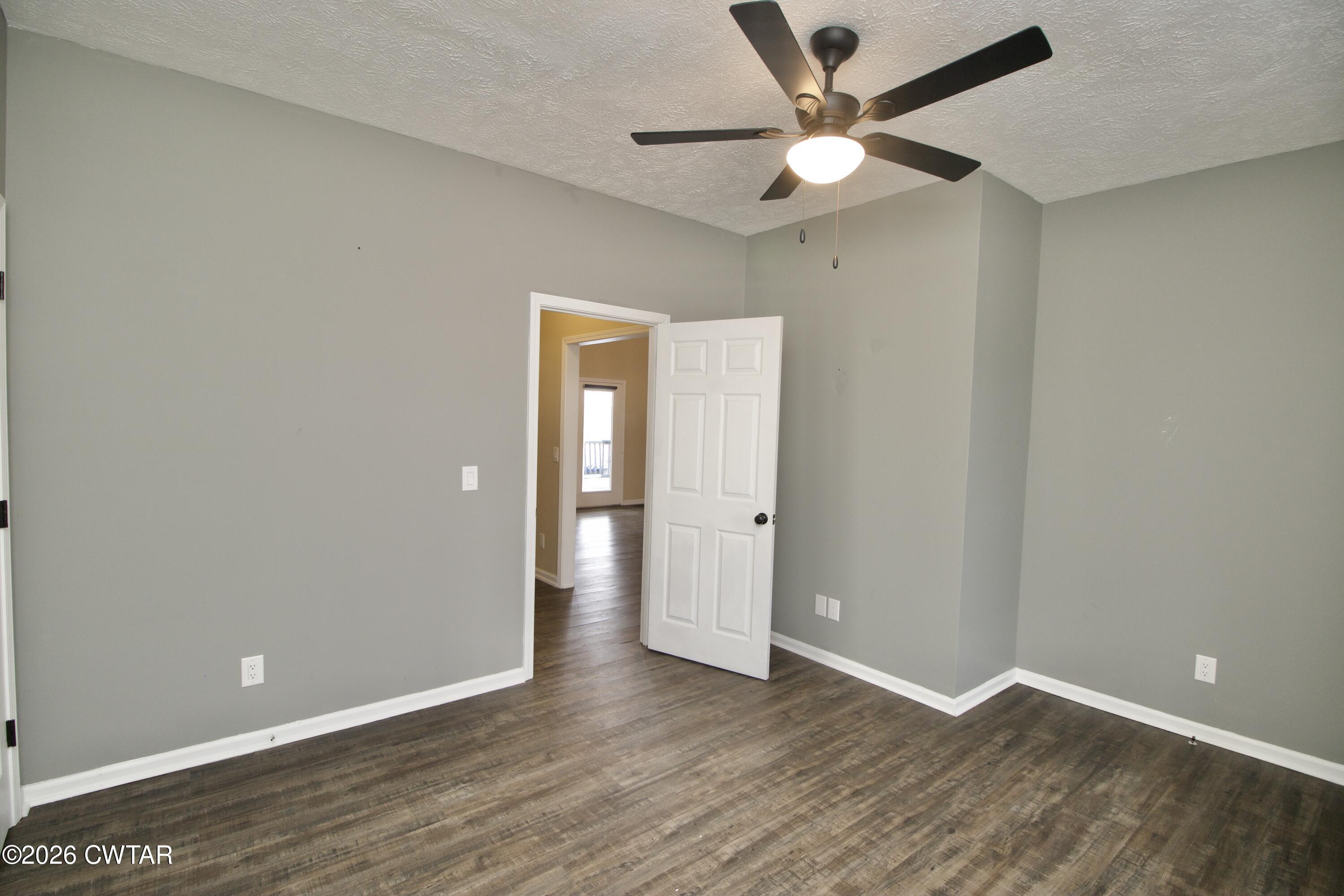 2845 Gilchrist Stantonville Road Stantonville, TN 38379 - Photo 45 of 97 an empty room with wooden floor and a ceiling fan