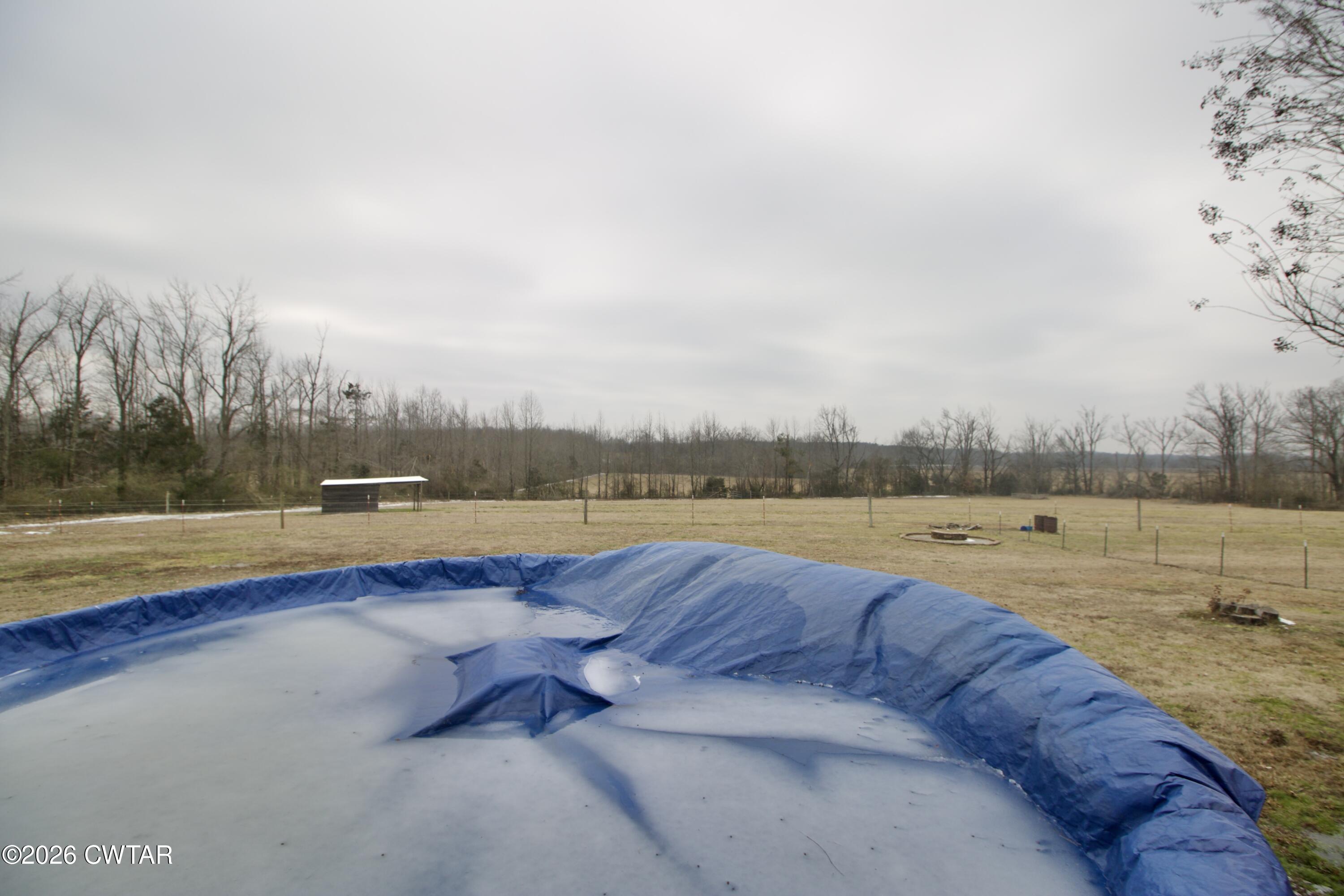 2845 Gilchrist Stantonville Road Stantonville, TN 38379 - Photo 55 of 97 a view of swimming pool with lake and mountain in the back