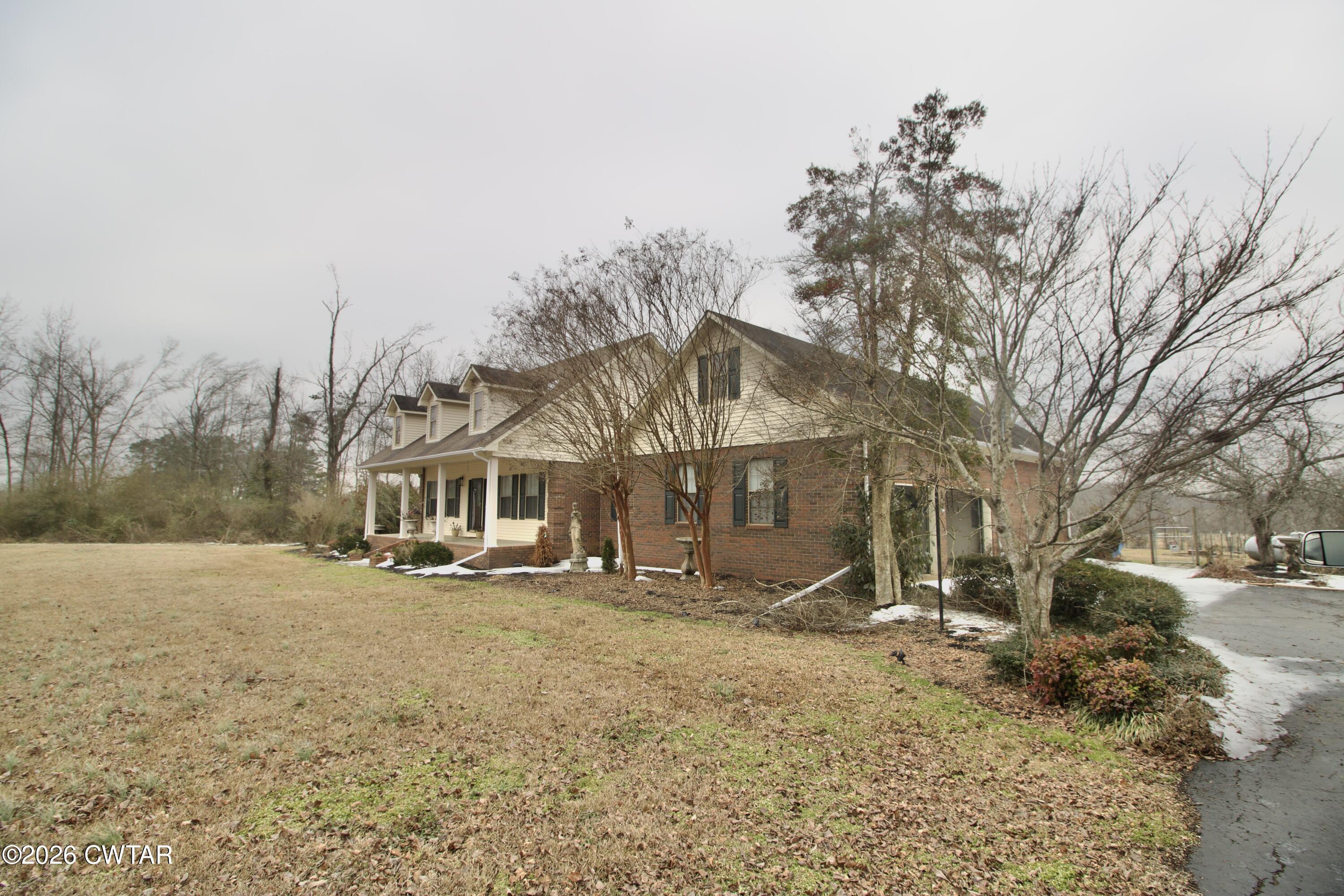2845 Gilchrist Stantonville Road Stantonville, TN 38379 - Photo 6 of 97 a front view of a house with a yard covered in snow